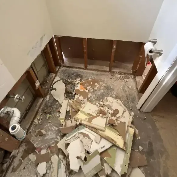 A bathroom opened to the studs after a sewage backup cleanup